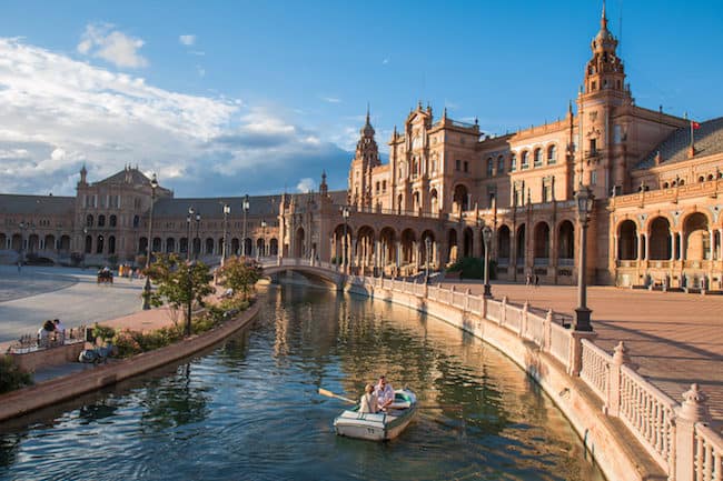 rowing a boat in plaza de españa, seville, spain travel