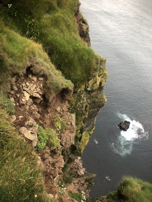 Peering over cliff edge